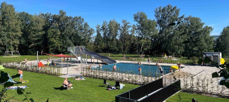 Liegewiese und Schwimmerbecken Freibad Bad am Wald mit Besuchern